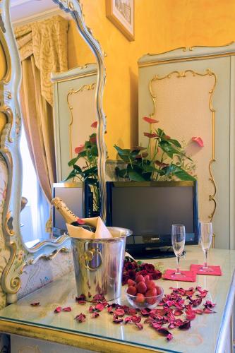 a table with a bowl of fruit and a tv at Hotel Villa San Lorenzo Maria in Rome