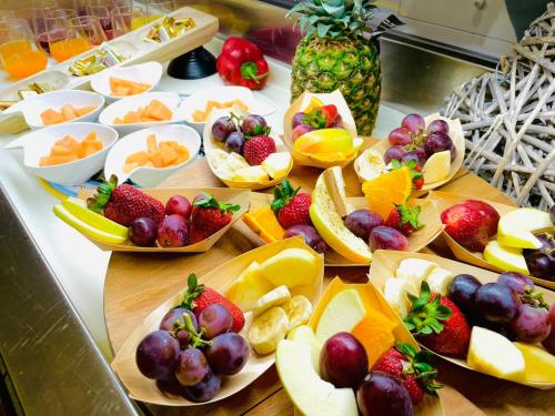 a table filled with fruits and vegetables in bowls at Hotel Okinawa in Rimini