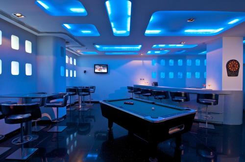 a blue room with a pool table and stools at Keys Select by Lemon Tree Hotels, Thiruvananthapuram in Trivandrum