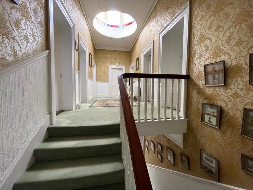 a staircase in a home with a hallway at Glenmore House B&B Mullingar in Mullingar