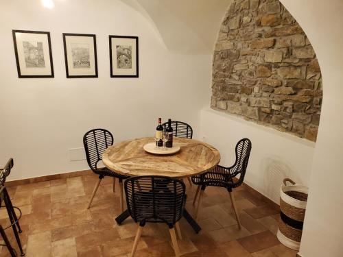 a dining room with a wooden table and chairs at Casa canadesi in Costarainera