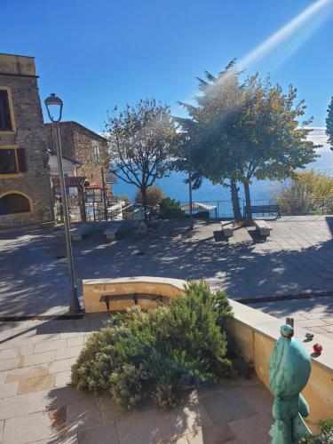 a park with a bench and a fire hydrant at Casa canadesi in Costarainera