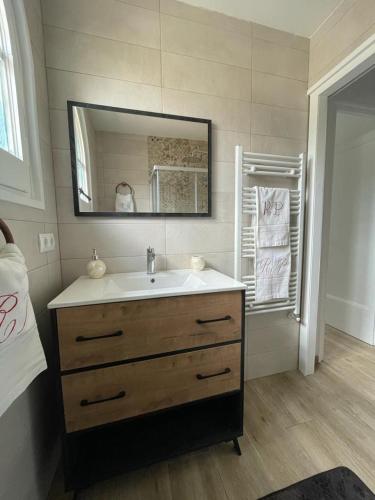 a bathroom with a sink and a mirror at Racó del Pirineu in El Pont de Suert