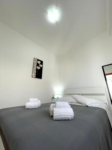 a bedroom with a bed with two white towels on it at Appartamenti Le Castella in Le Castella