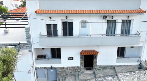 a white building with a balcony at 3SSS Bouquet Studios in Marmarion