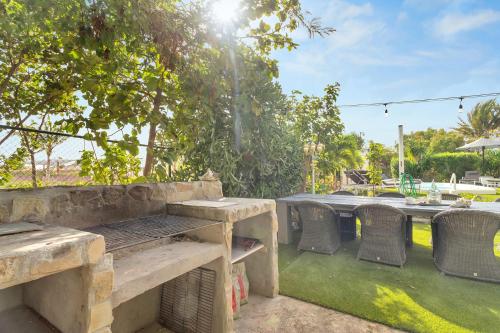 a picnic table and chairs on a patio at Apartment Delfin at Windsock Beach in Kralendijk