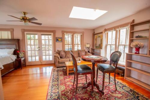 a living room with a couch and a table and chairs at California Cottage in Jacksonville