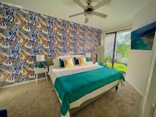 a bedroom with a bed and a large window at Tropical Breeze - 2BR/NRG/Medical Center/Galleria in Houston