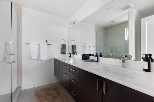 a bathroom with a sink and a large mirror at Deactivated- Rooftop Patio with Grill 2BR 3BA Central, Walkable Location in Seattle