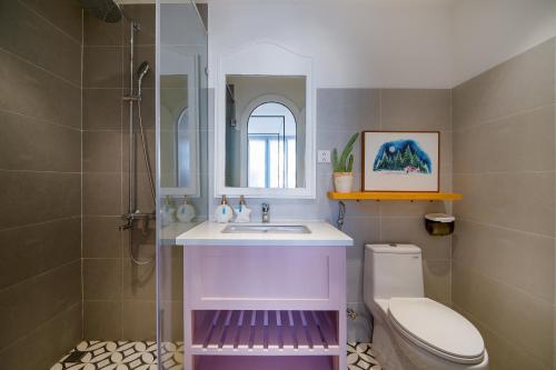 a bathroom with a sink and a toilet at Santori Hotel And Spa in Da Nang