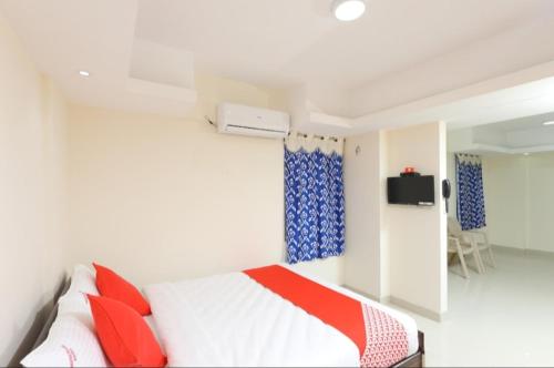 a bedroom with a bed and a tv on a wall at PHOENIX INN in Chennai
