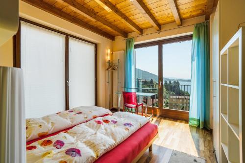a bedroom with a bed and a large window at Casa Marina in Mergozzo
