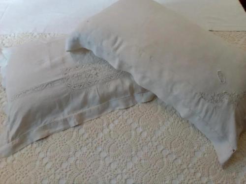 a bed with a white pillow on top of it at CASA VACANZA LA VILLA in Amelia