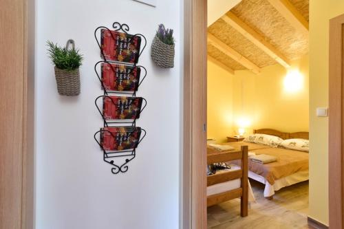 a hallway with a room with a bed and a shelf with plants at Holiday home with swimming pool, donkeys and horses in Vrlika