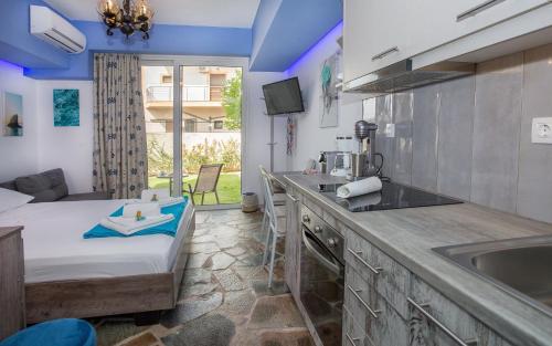 a kitchen with a sink and a bed in a room at 3SSS Bouquet Studios SEA in Marmarion