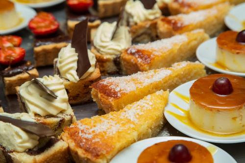 a bunch of desserts on plates on a table at Le Ndiambour Hôtel et Résidence in Dakar