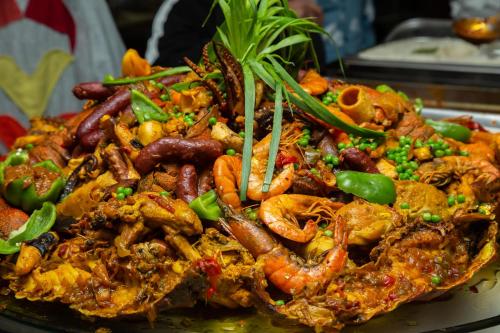 a plate of food with shrimp and other foods at Le Ndiambour Hôtel et Résidence in Dakar