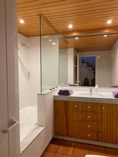 a bathroom with a tub and a sink and a shower at Can Ramon in Cadaqués