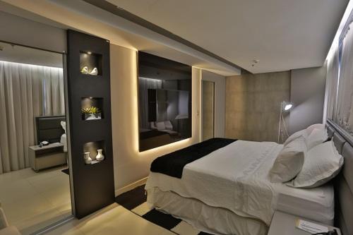 um quarto de hotel com uma cama e uma televisão em Uchôa Teresina Hotel em Teresina