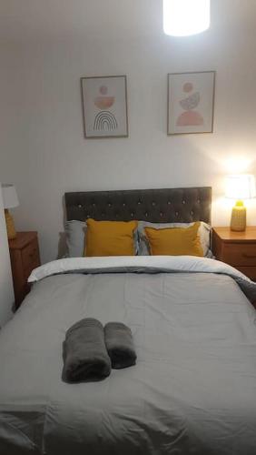 a bedroom with a large bed with two pillows on it at White Shelf Dartford House in Kent