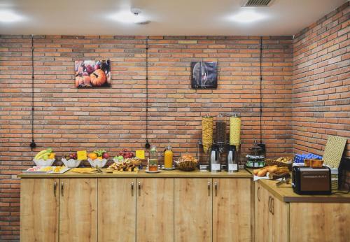 uma cozinha com um balcão com uma parede de tijolos em Address Boutique Hotel em Tbilisi