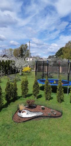 a garden with a park with a playground at Лора in Lapmežciems
