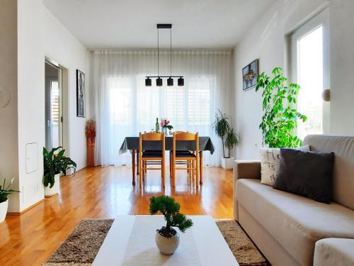 uma sala de estar com uma mesa e um sofá em Apartment Violetta-Punta em Umag