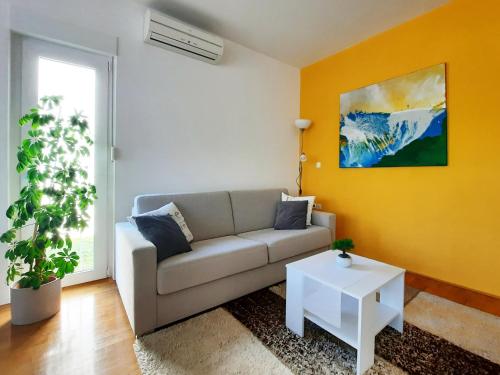 a living room with a couch and a table at Apartment Violetta-Punta in Umag