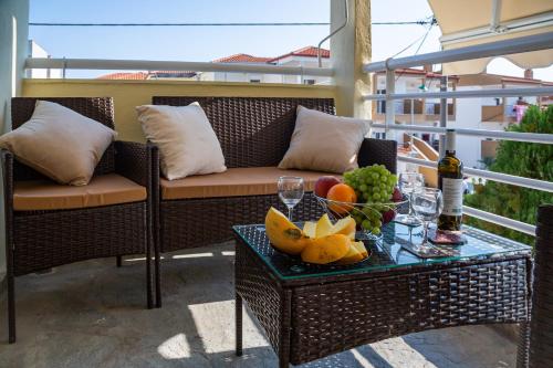 a table with a bowl of fruit on a balcony at Apartment in Skala Fourkas in Skála Foúrkas