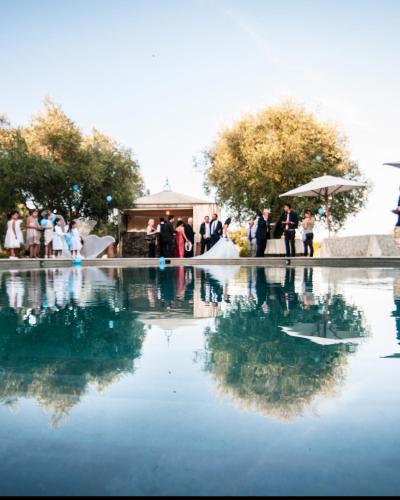 a group of people standing around a pool of water at Fattoria Pianetti in Manciano