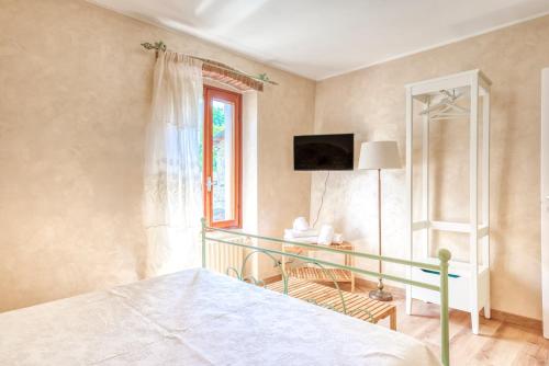 a bedroom with a bed and a window at Oasi Borghetto Verde in Castellaro