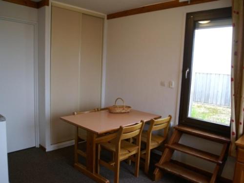 une pièce avec une table, des chaises et une fenêtre dans l'établissement Studio cabine au pied des pistes avec balcon et terrasse - FR-1-557-21, à Les Adrets