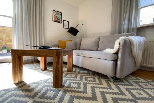 a living room with a couch and a table at Ferienapartment Weber in Faßberg
