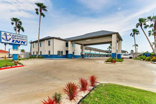 a large building with a sign in front of it at Captains Quarters Inn in Port Aransas