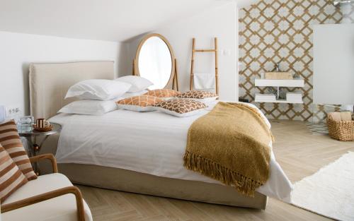 a bedroom with a bed with pillows and a mirror at Gallery Luxury Suites & Rooms-Only Adults in Split