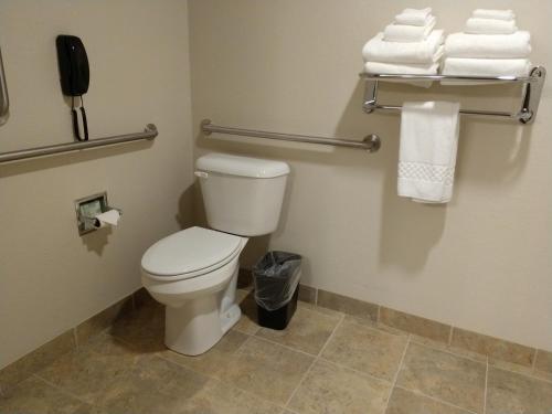 a bathroom with a toilet with towels and a phone at Cobblestone Inn & Suites - Monticello in Monticello