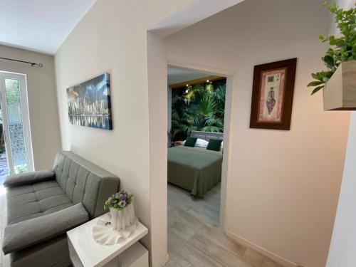 a living room with a couch and a bedroom at Villa Norah in Podgora
