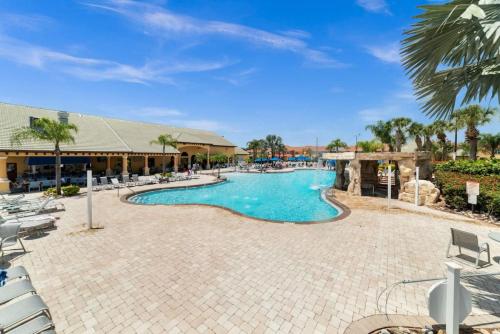 a swimming pool at a resort with lounge chairs at Paradise Villa Disney Staycation Pool, Fun & Resort Access in Kissimmee