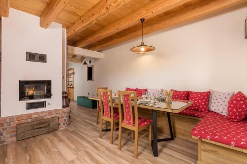 a living room with a couch and a table and chairs at Mountain house Beauty of Laz in Ravna Gora