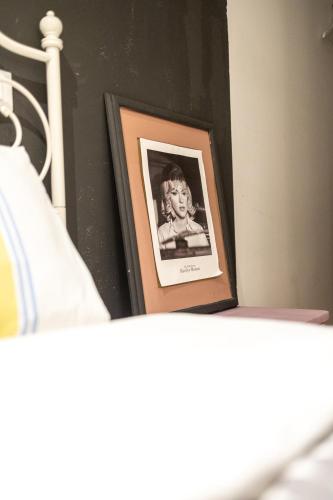 a picture of a child in a frame on a bed at Piran Holiday Apartments in the city center in Piran