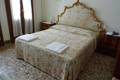 a bedroom with a bed with two towels on it at Pensione Seguso in Venice
