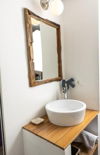 a bathroom with a sink and a mirror at Piran Holiday Apartments in the city center in Piran