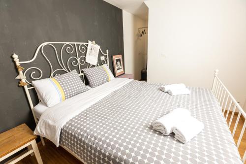 a bedroom with a bed with two towels on it at Piran Holiday Apartments in the city center in Piran