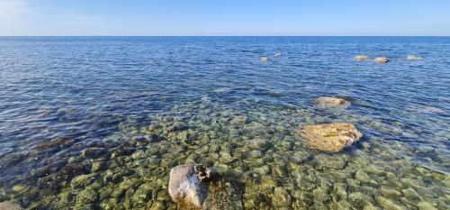 a large body of water with rocks in it at B&B Aria di Mare - Pollina Sicilia in Finale