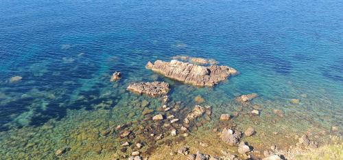 an aerial view of a rocky island in the water at B&B Aria di Mare - Pollina Sicilia in Finale