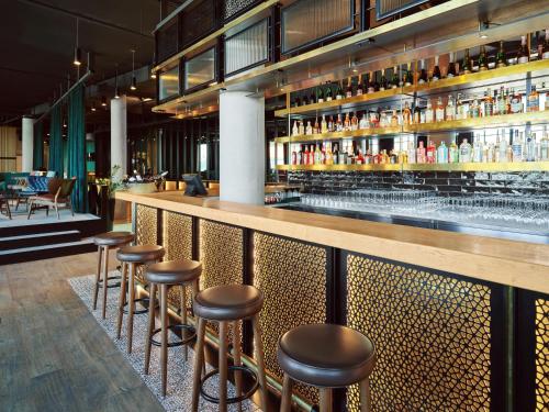 a bar at a restaurant with stools at Mövenpick Zagreb in Zagreb