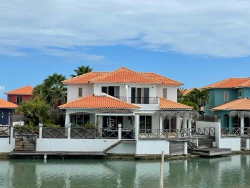a large house on the water next to a lake at Kas Felis in Watervillas in Kralendijk