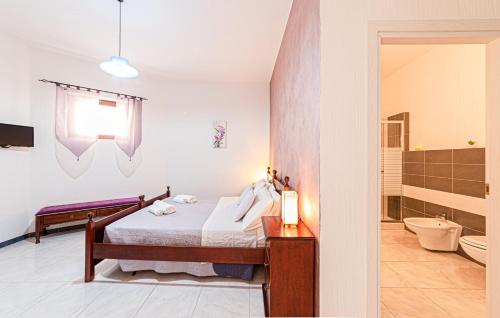 a bedroom with a bed and a bathroom at Affittacamere Nonno Natalino in Castelsardo