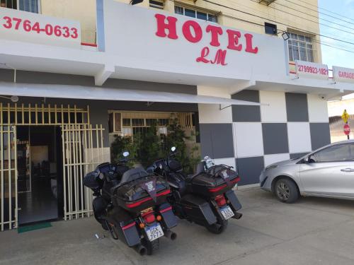 two motorcycles parked in front of a hotel at Hotel Lm in Pedro Canário