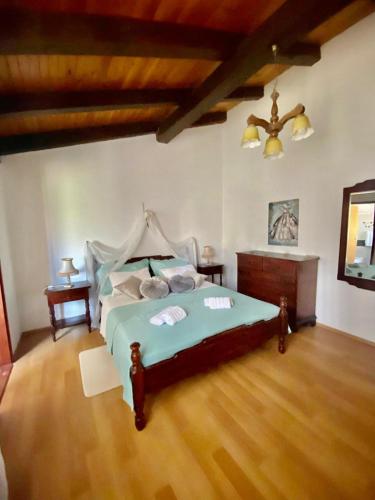 a bedroom with a bed and a wooden floor at Vila La Perla Istriana in Višnjan